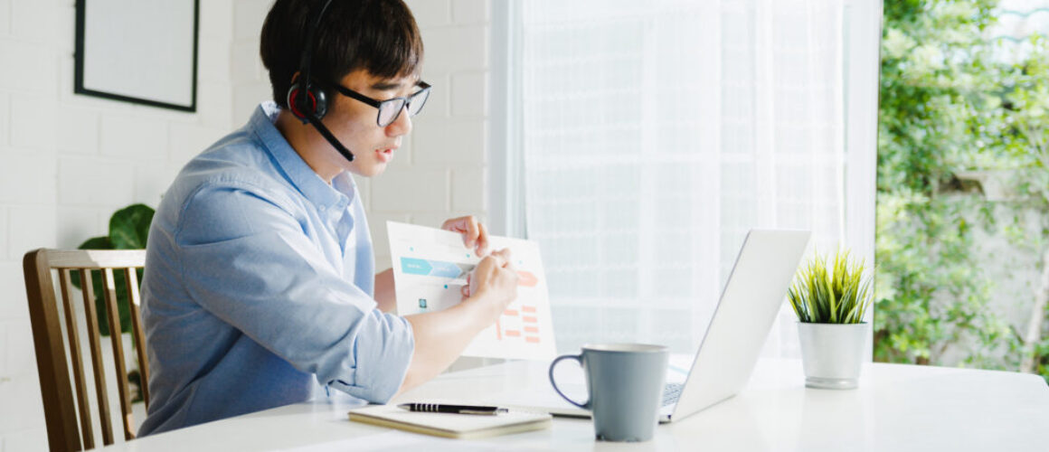 Young Asia businessman using laptop talk to colleagues about pla
